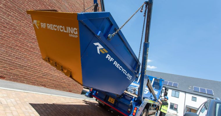 rf recycling skip being raised on to a truck