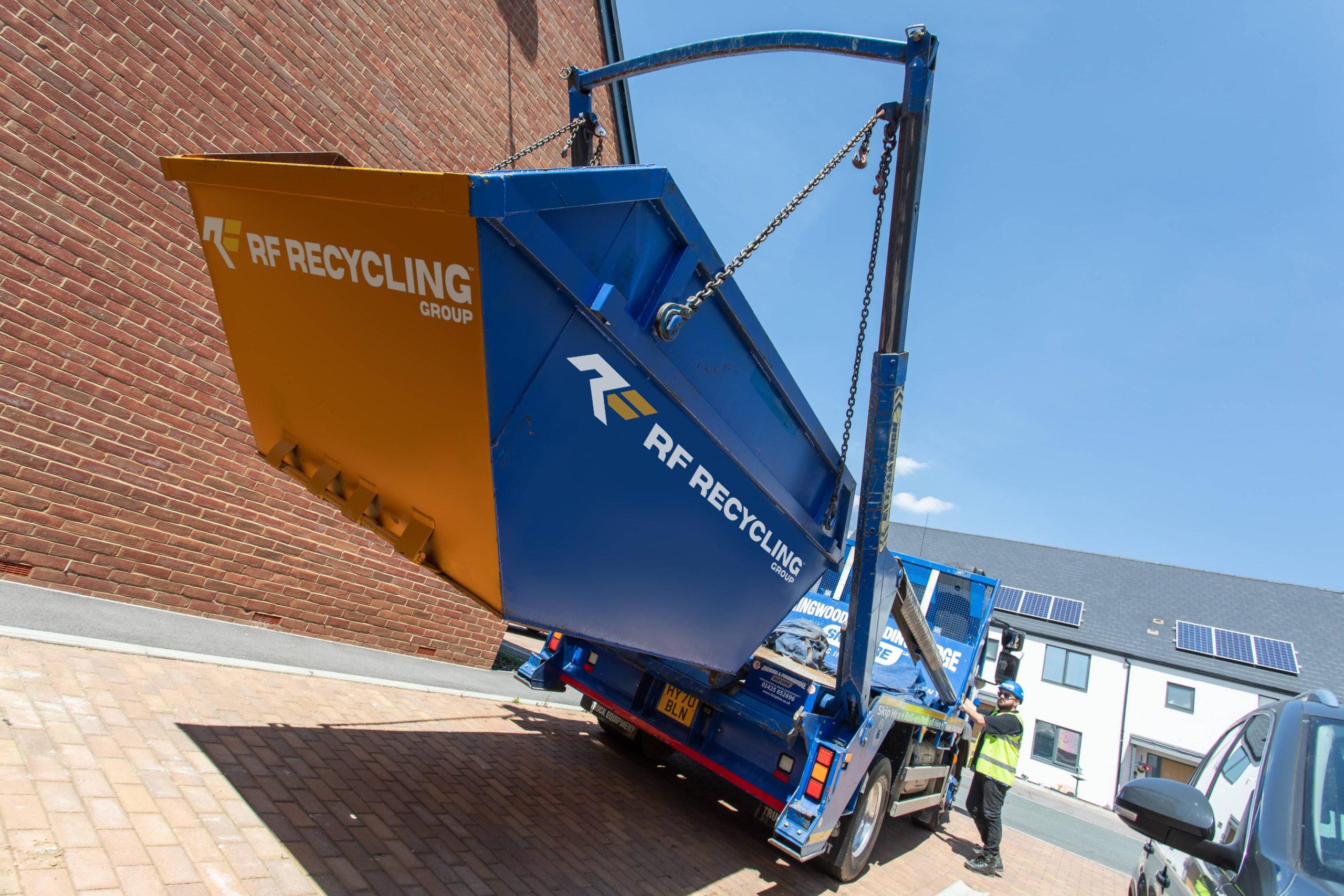 rf recycling lorry picking up a skip