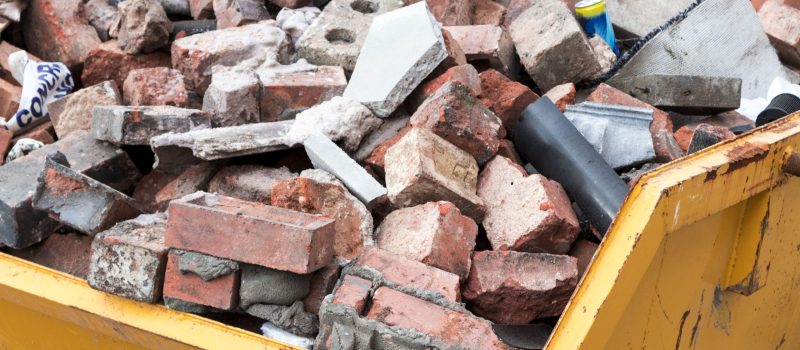 domestic skip with bricks in