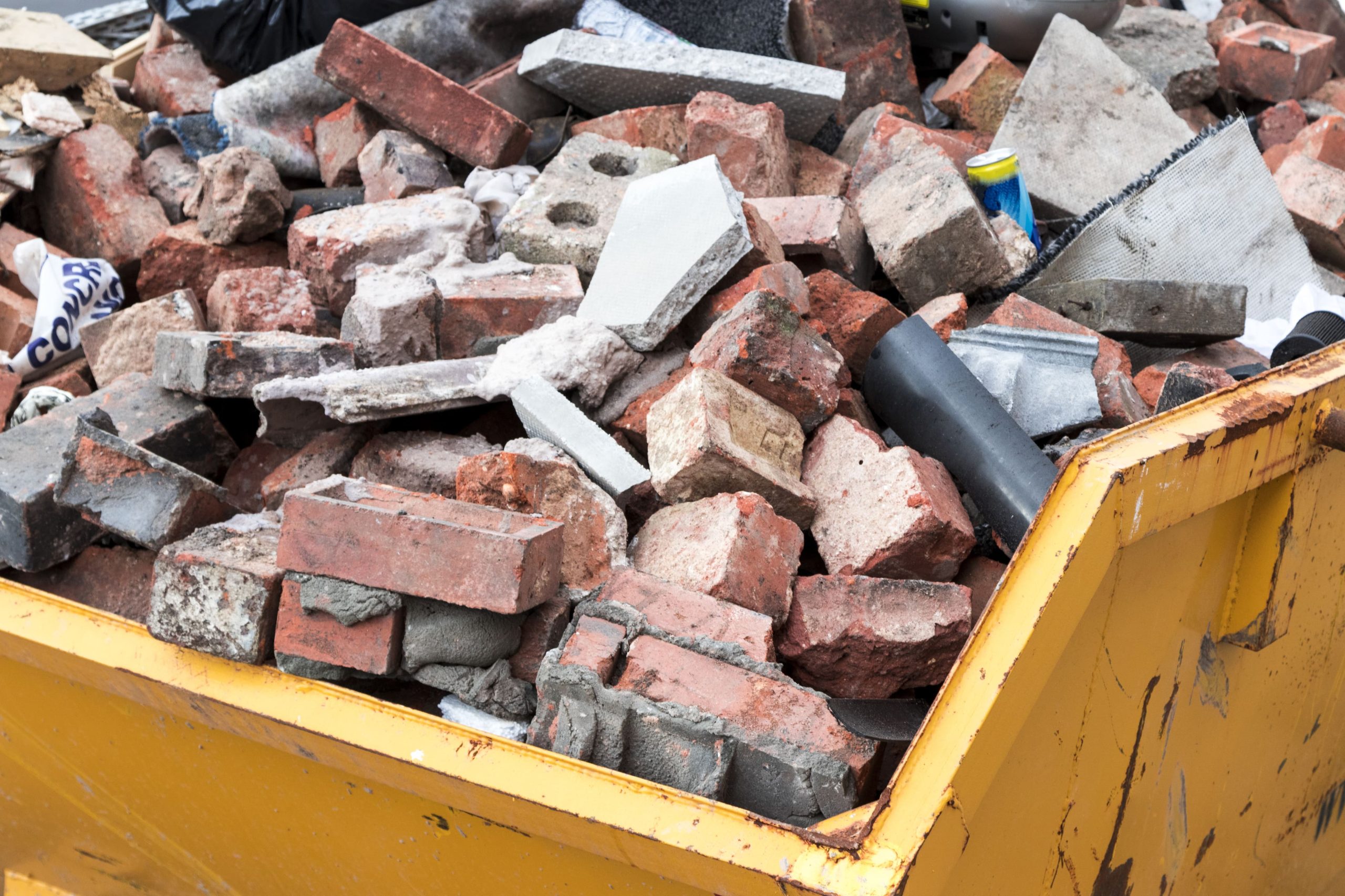 domestic skip with bricks in