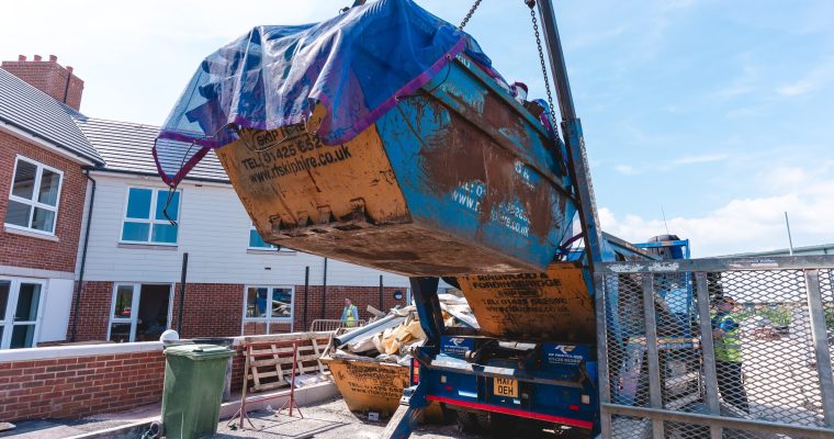 a skip being carried to be returned to recycling centre