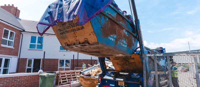 a skip being carried to be returned to recycling centre