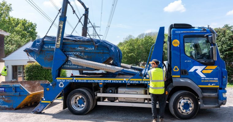 rf recycling group lorry picking up a skip