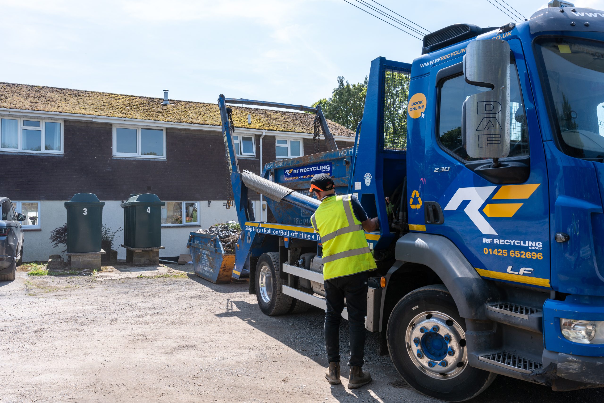 skip hire at rf recycling taking place outside home