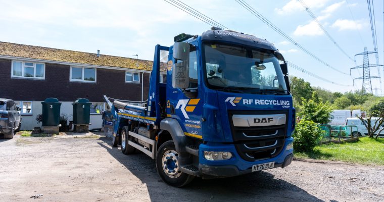 skip lorry in front of a house